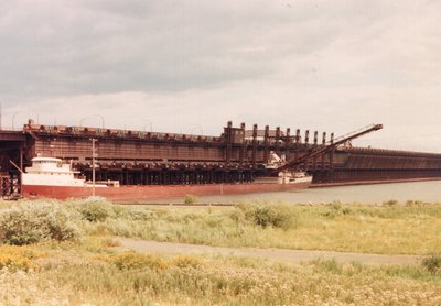 A few trees in the way, but Armco loading at the D.M. &amp; I.R. Shiploader. 8/6/89.