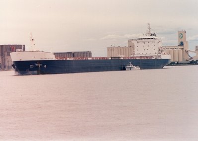 Outbound Duluth from Peavey-Connor's Pt. with pilot boat Twin Ports Belle alongside. 9/10/89.