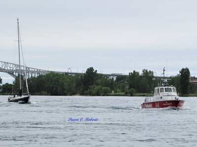 Eliza Grace zipping into the St. Clair River towing a sailboat at a speed likely never before imagined by its skipper!