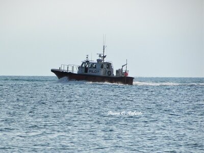 The pilot boat follows closely behind.