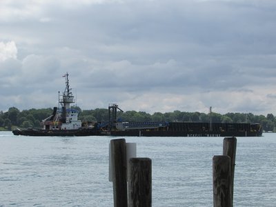 Leonard M. and barge Huron Spirit moving toward Detroit, under unsettled skies.