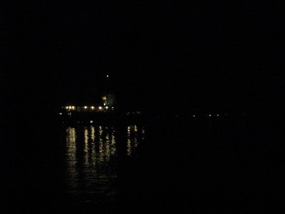 Kaye E. Barker's lights reflected in the rippled waters of the river as she makes her way toward AK-Rouge.