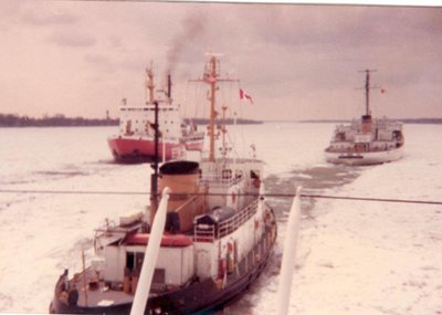 U.S.C.G. Bristles, Canadian DeGenuay and the Mighty Mac. breaking ice or the stuck Oakglen.                       Metz Photo