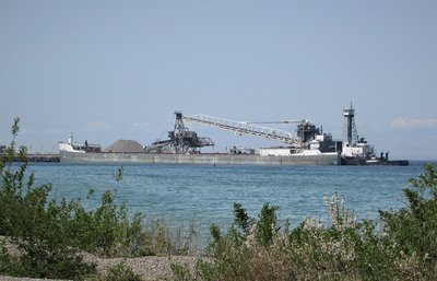 Stone pouring into Olive L. Moore's holds as she sits at the Stoneport dock.