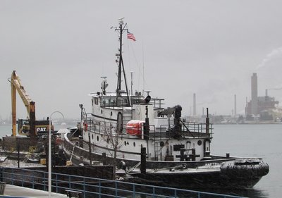 Tug Manitou, with flag flying, at her dock above Marysville.
