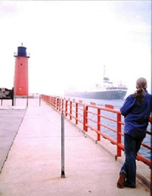 My Brother standing on the breakwall watching my ship going out through the piers into foggy Lake Michigan.