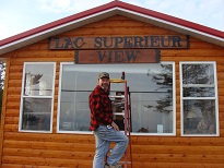My Son Dick Jr. putting up my sign over looking the lake.
