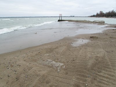 Yesterday afternoon, I stood in front of the breakwall, (under the sign) taking pictures. This is how it looked 18 hours later. The beach still shows signs of recent grooming, but the  definite border between the sand and water is gone.