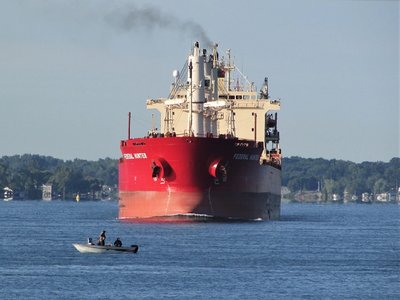 A perfect example of what freighters face every day on the St. Clair River. I could almost hear the fishermen insisting, "This river is wide enough for you to go around us," but as she got closer they drifted out of the channel.