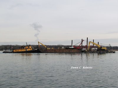 Madison R (Toledo) follows close behind with a loaded work barge.