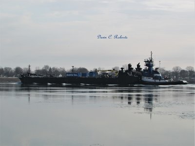Bow wake ripples along barge Endeavour.