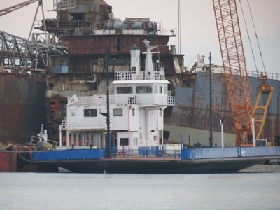 Car ferry at International Marine Salvage scrapyard in Port Colborne, Ontario with the remains of Algoway and Algorail in background.