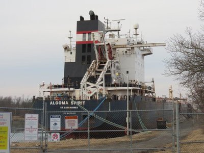 Stern of the Algoma Spirit at Wharf 12, Stone dock in Port Colborne, Ontario safely secured behind the fence.