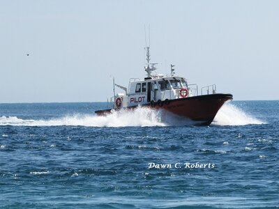 Supply boat Huron Spirit racing back to dock on the Black River.
