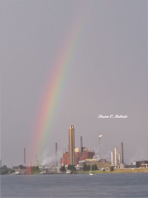 When clouds began breaking up to the west, this rainbow "finger" appeared, drawing people in off the road to enjoy and photograph it!