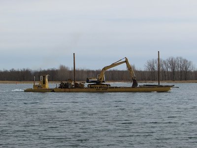 Small tug and barge passing down river at Sans Souci.